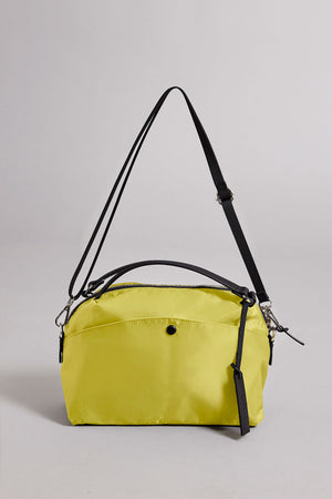 The NYLON CROSSBODY BAG by Velvet by Graham & Spencer is a yellow rectangular nylon bag with a black adjustable shoulder strap, top handle, front button pocket, and zippered main compartment—ideal for daily use.