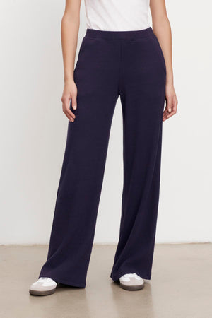 A woman wearing Velvet by Graham & Spencer's KACIE BRUSHED RIB PANT and white t-shirt.