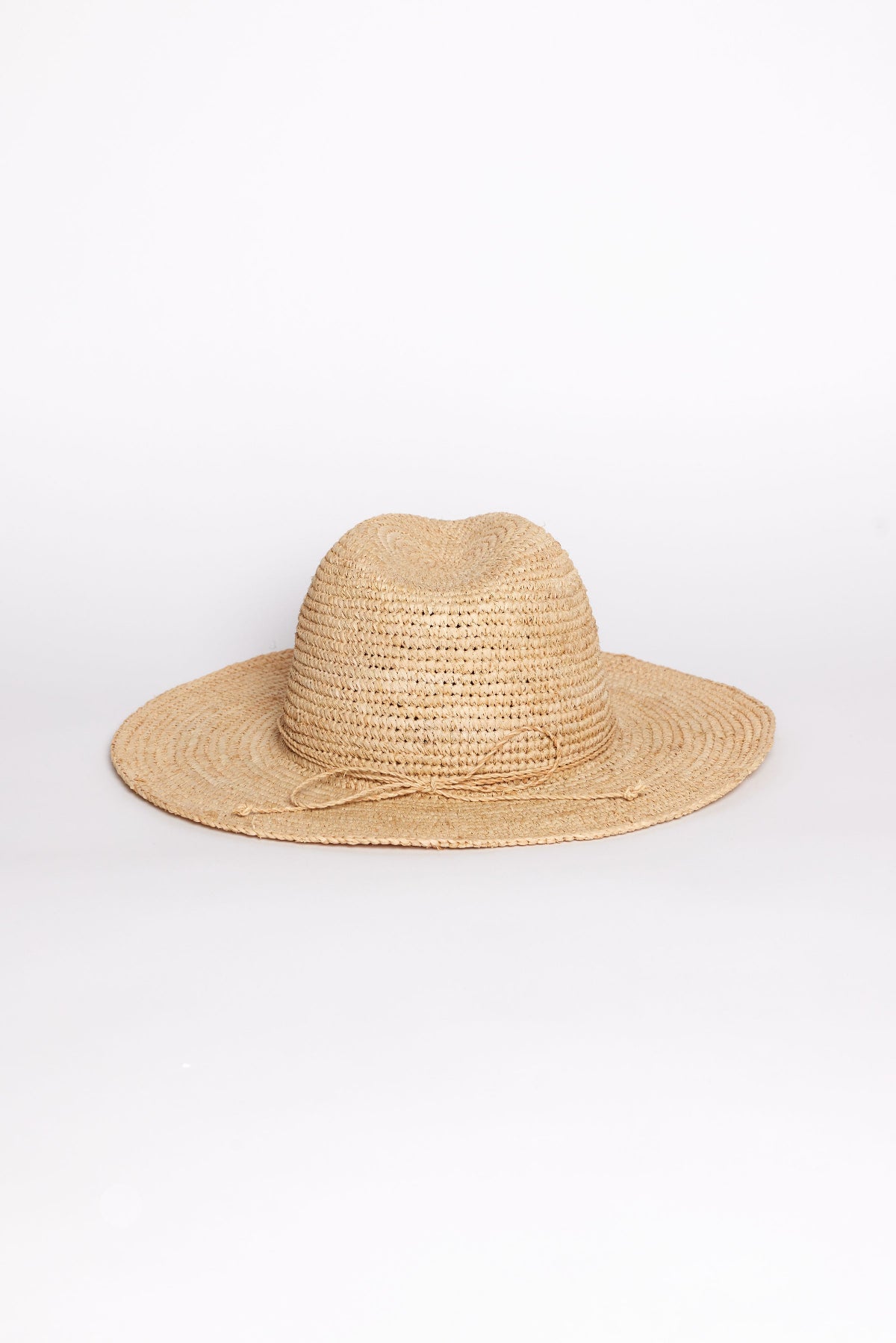 The AMELIA FEDORA by Velvet by Graham & Spencer, a wide-brimmed natural straw hat, is displayed against a plain white background.-41393572479169