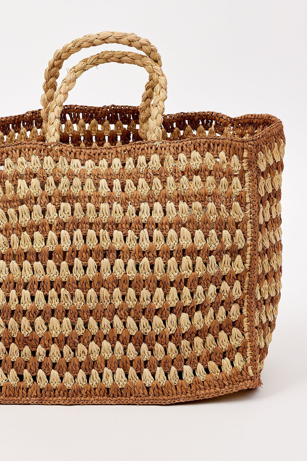 The MELODY BAG by Velvet by Graham & Spencer is a rectangular woven straw bag with two braided handles and a checkered pattern, shown against a plain white background.-41393567760577