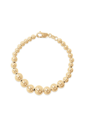 The Graduate Bracelet by Phyllis+Rosie, featuring a gold beaded design and lobster clasp closure, effortlessly chic and reminiscent of vintage street culture.