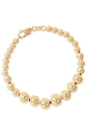 Introducing THE GRADUATE BRACELET BY PHYLLIS AND ROSIE, a gold beaded bracelet from Phyllis+Rosie featuring a series of polished spherical beads with a lobster clasp closure, effortlessly chic yet resonating with vintage street culture.