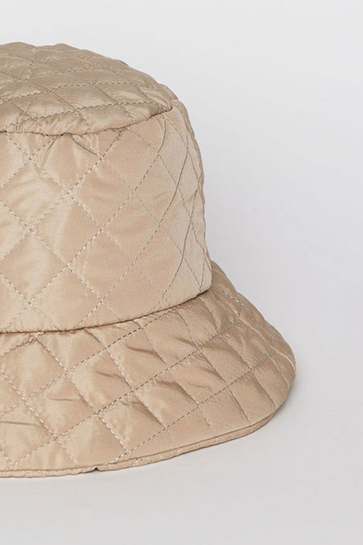 The MODERN QUILTED BUCKET HAT by Velvet by Graham & Spencer features a beige color with a diamond stitching pattern on a white background.-38485968322753