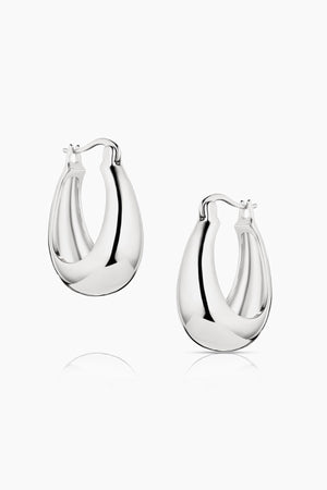 Two teardrop-shaped, silver PETITE LUMI HOOP EARRINGS BY THATCH are displayed on a white background.