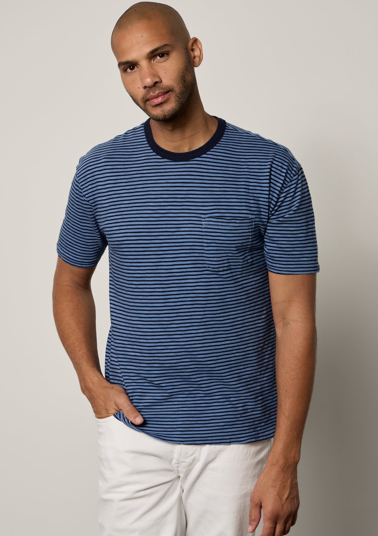 Jeremy Crew Neck Tee with medium and dark blue stripes, front pocket, paired with white denim front