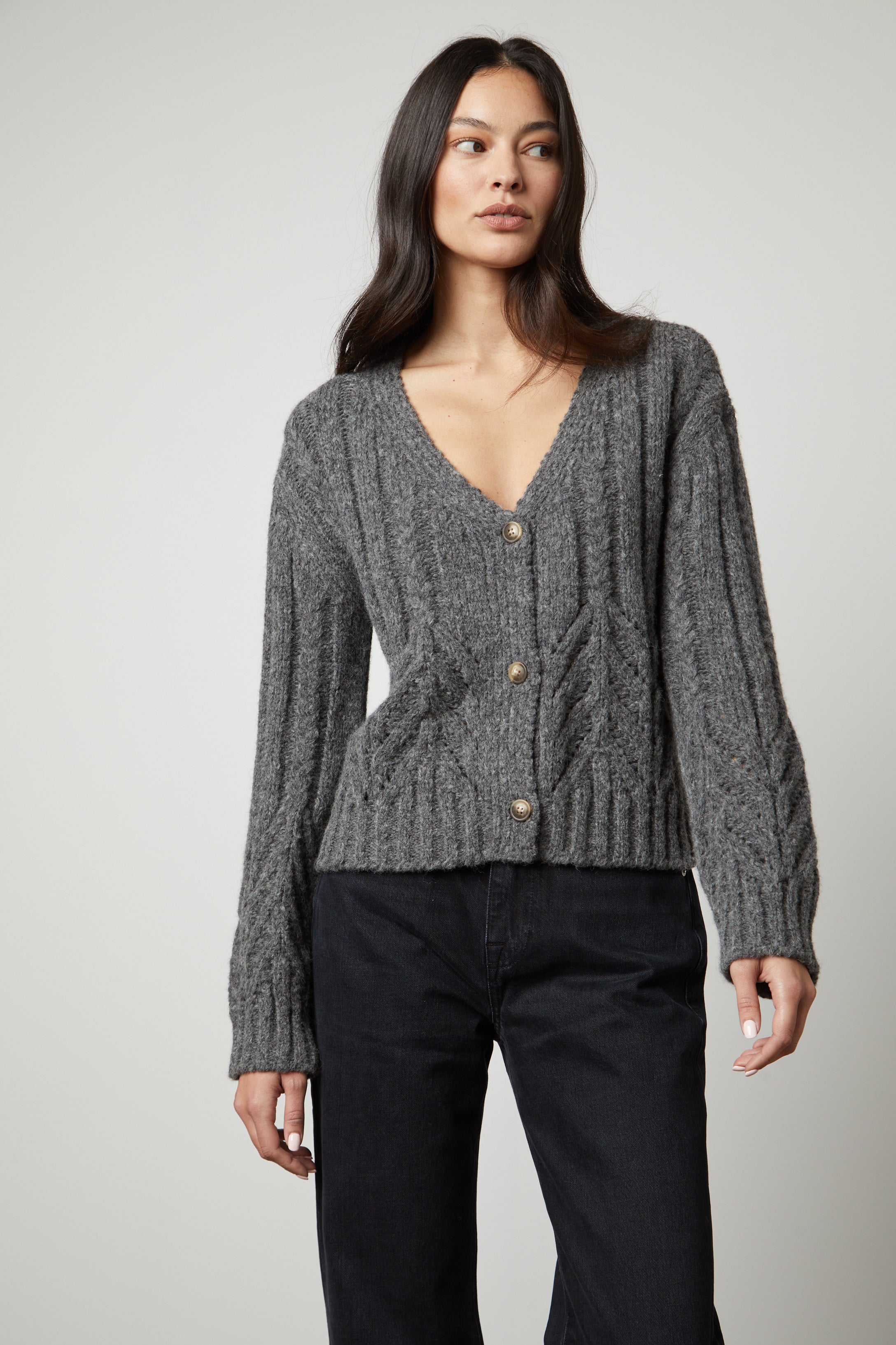 The model is wearing a Velvet by Graham & Spencer Hazel Alpaca Cable Knit Cardigan.