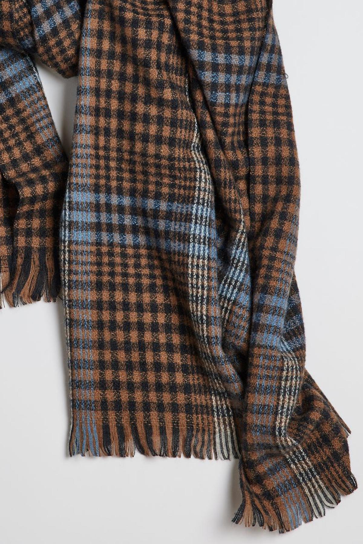 A BOSTON PLAID SCARF with fringe on a white surface. (Brand: Velvet by Graham & Spencer)