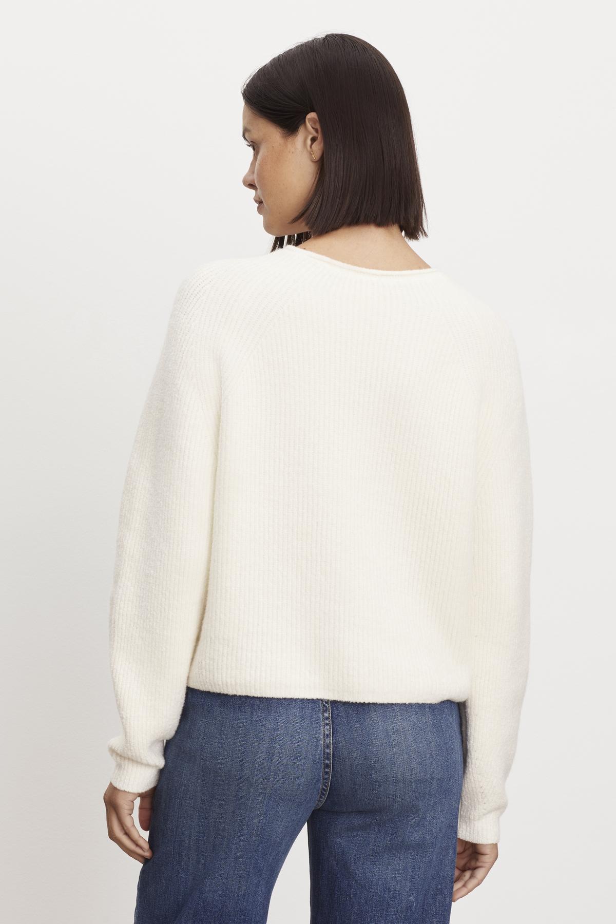 The back view of a woman wearing a Velvet by Graham & Spencer BOWIE BOUCLE CREW NECK SWEATER and jeans.-36095783141569