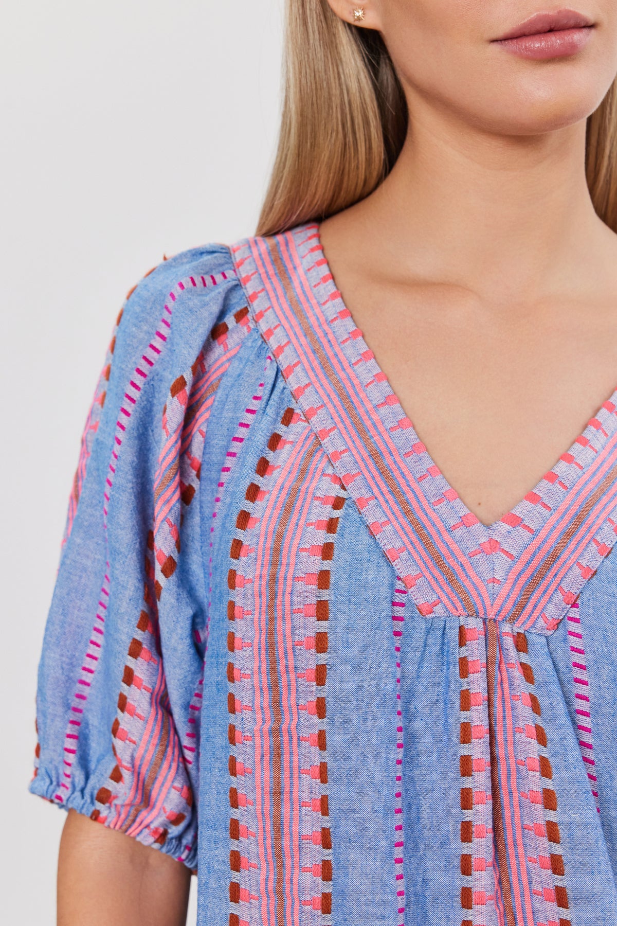 Close-up of a woman wearing a ZOELLE DRESS by Velvet by Graham & Spencer, focusing on the fabric detail and cotton jacquard neckline.-36910102380737