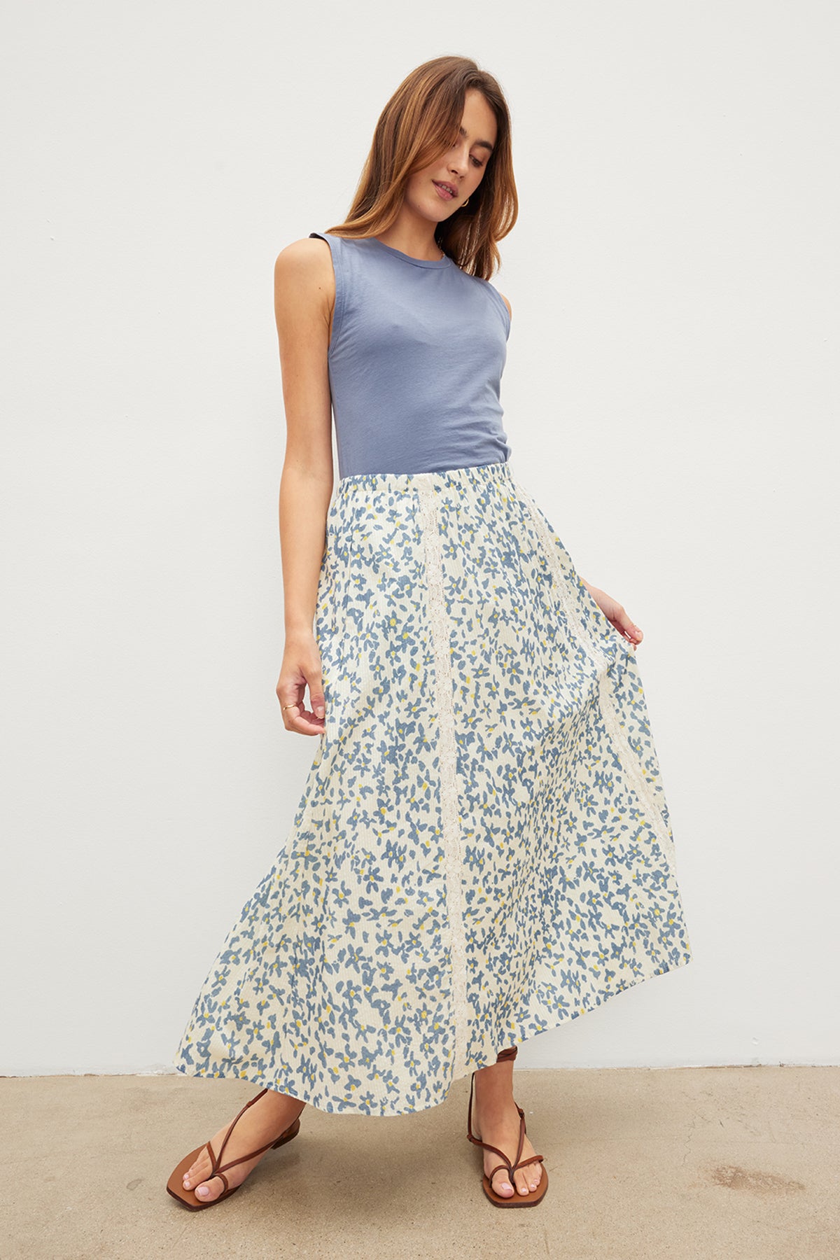 A woman wearing a Velvet by Graham & Spencer KONA FLORAL LACE MAXI SKIRT with an elastic waist.-35967624511681