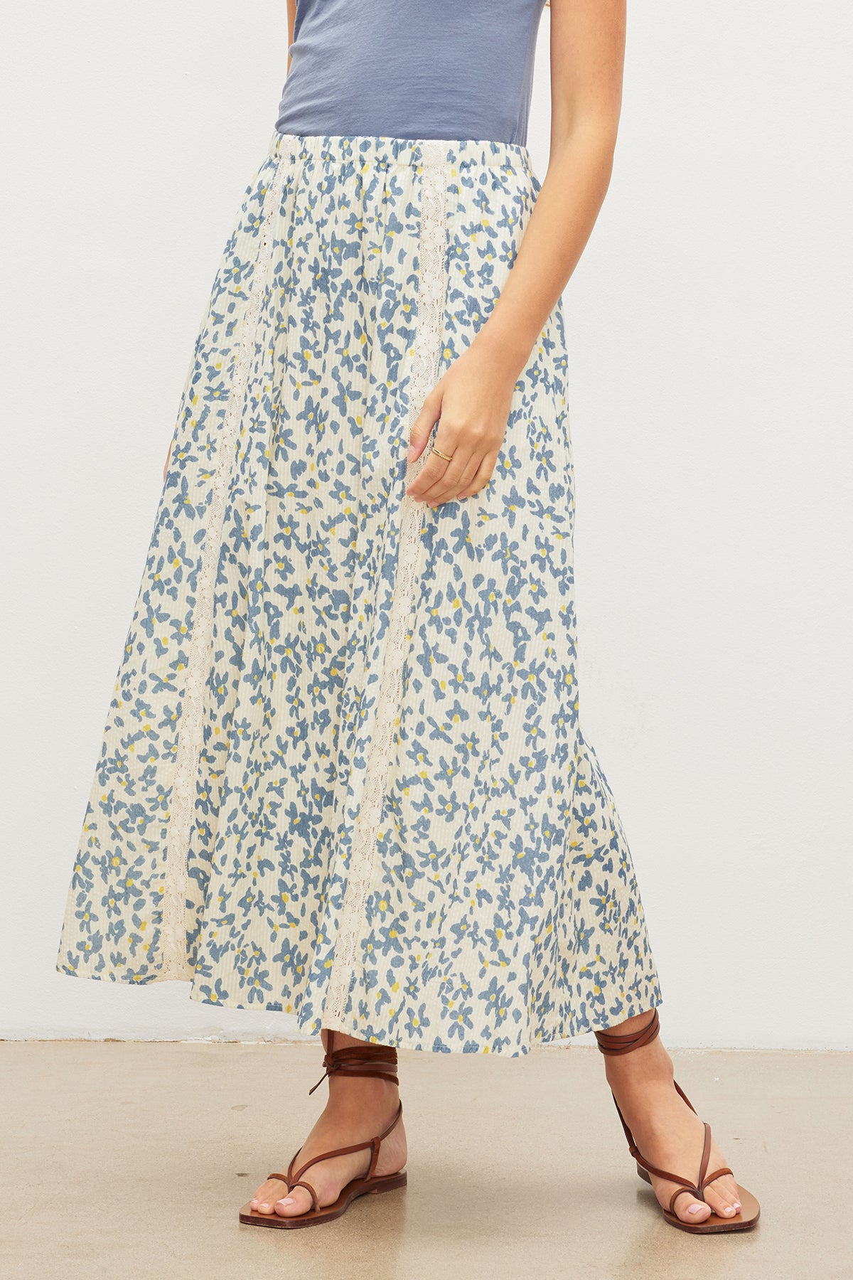 A woman wearing the Velvet by Graham & Spencer KONA FLORAL LACE MAXI SKIRT with an elastic waist.-35967624544449