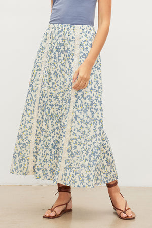 A woman wearing the Velvet by Graham & Spencer KONA FLORAL LACE MAXI SKIRT with an elastic waist.