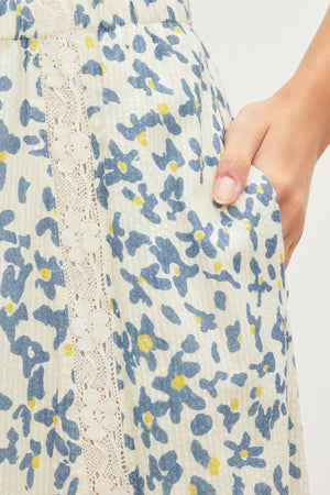 A woman wearing a Velvet by Graham & Spencer KONA FLORAL LACE MAXI SKIRT with an elastic waist.