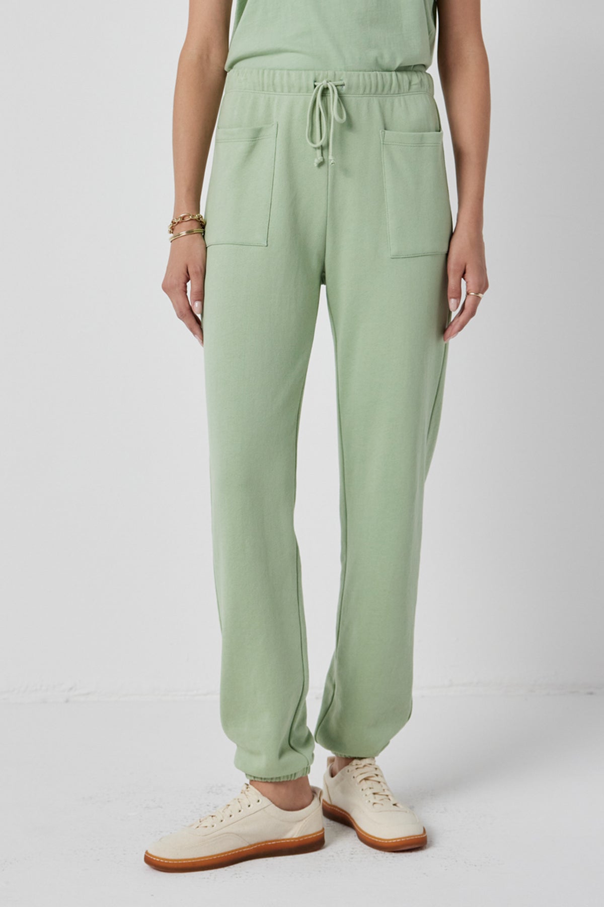 A woman wearing WESTLAKE SWEATPANTS by Velvet by Jenny Graham and a white tee.-36168747647169