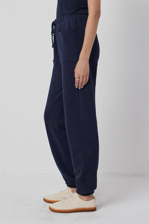 A woman wearing Velvet by Jenny Graham WESTLAKE SWEATPANT and a white t - shirt.
