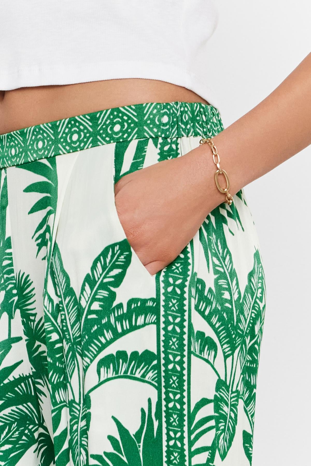 Close-up of a person's hand partially tucked into the pocket of a Velvet by Graham & Spencer IRIS PANT.-36917074133185