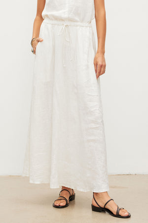 A woman wearing the Velvet by Graham & Spencer BAILEY LINEN MAXI SKIRT.
