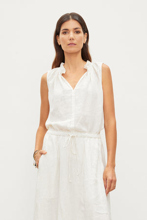 The model is wearing a white Velvet by Graham & Spencer MASIE LINEN TANK TOP.