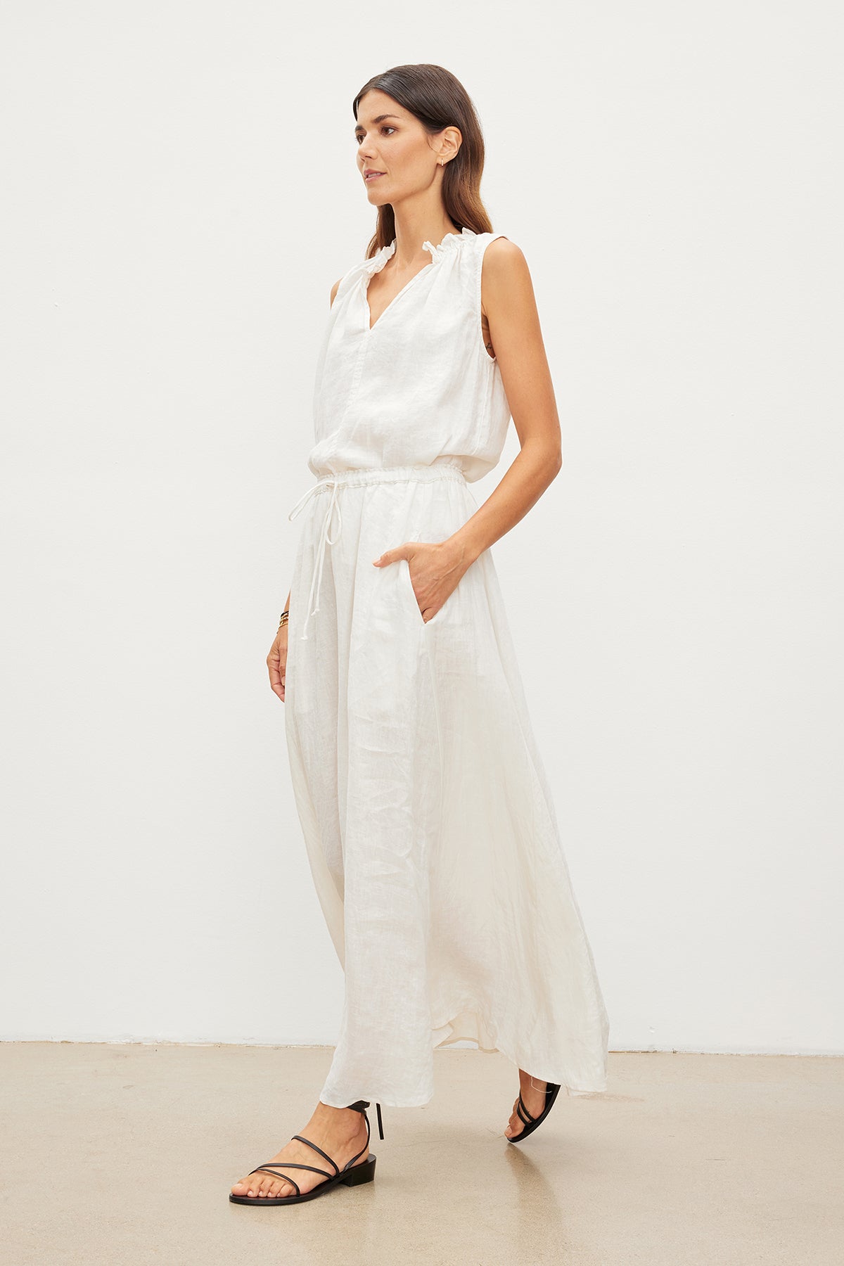 The model is wearing a white MASIE LINEN TANK TOP dress and Velvet by Graham & Spencer sandals.-36010172317889