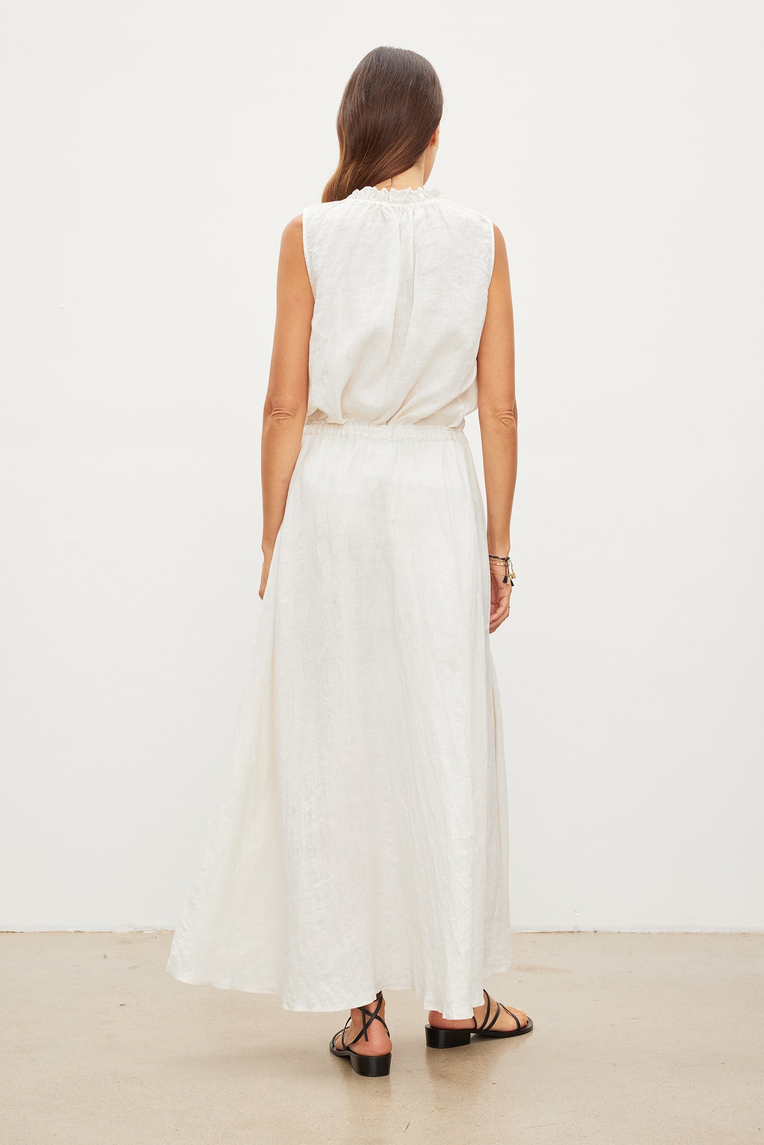 The back view of a woman wearing a Velvet by Graham & Spencer MASIE LINEN TANK TOP.