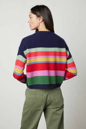 The back view of a woman wearing a Velvet by Graham & Spencer KACEY CASHMERE STRIPED CREW NECK SWEATER.