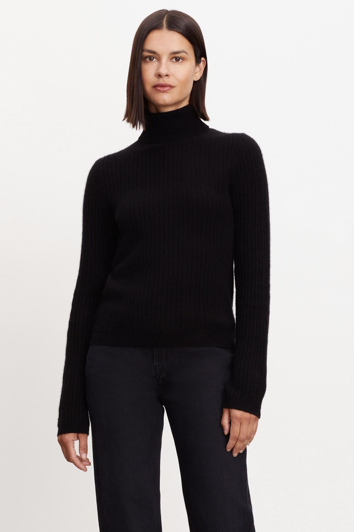 A woman wearing a Velvet by Graham & Spencer LORI CASHMERE TURTLENECK SWEATER.