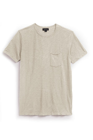 The CHAD TEE by Velvet by Graham & Spencer is a light beige short-sleeve T-shirt made from soft Peruvian cotton, featuring a crew neckline and a chest patch pocket, shown laid flat on a white background.