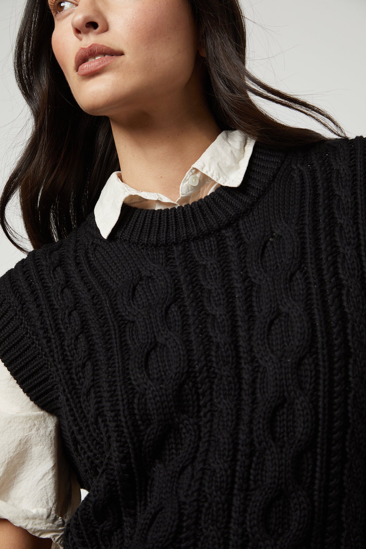 The model is wearing a black Velvet by Graham & Spencer HADDEN SWEATER VEST.-26799841181889