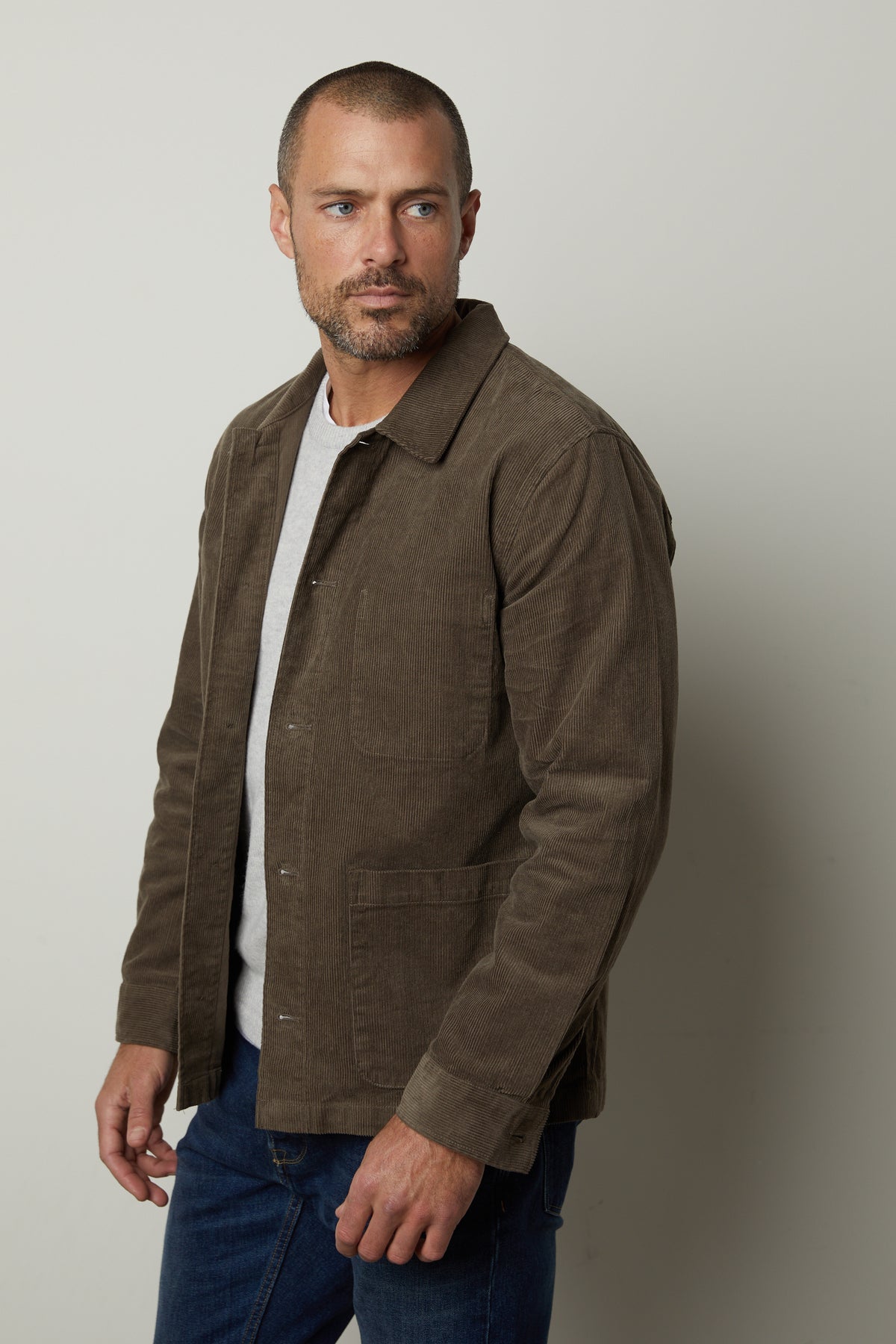A man sporting a REIKO corduroy chore jacket by Velvet by Graham & Spencer for practicality and style.-26846359355585