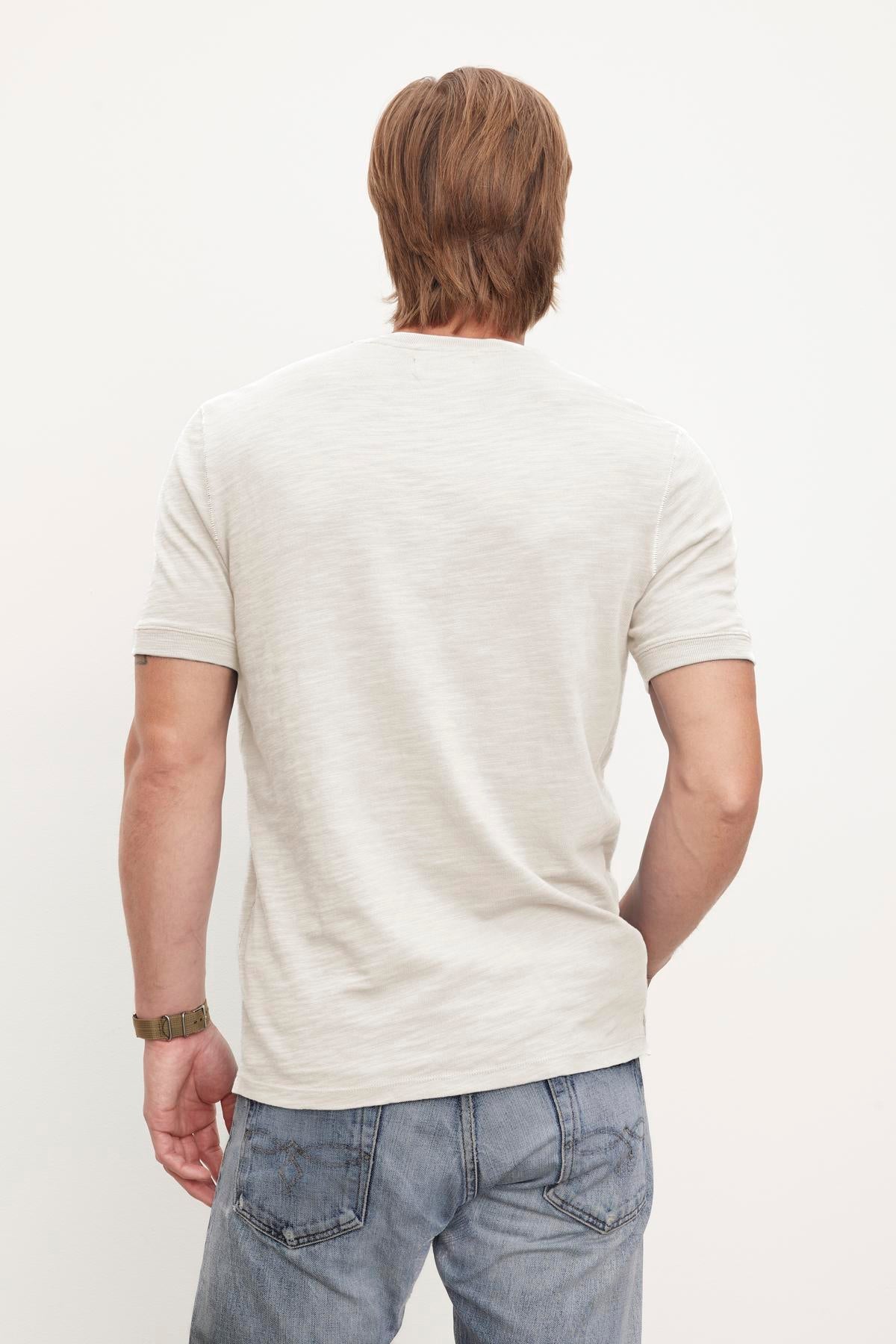 The back of a man wearing Velvet by Graham & Spencer jeans and a t-shirt.-36009082224833