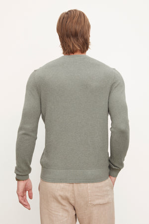 The back view of a man wearing a long-sleeve grey Velvet by Graham & Spencer ACE THERMAL CREW made of cotton with cashmere.