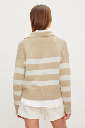 A woman wearing a Velvet by Graham & Spencer LUCIE POLO SWEATER made of cotton/cashmere.