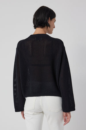 Someone with short hair is wearing the Velvet by Jenny Graham KANAN Cotton Cashmere Mesh Sweater in black and white pants, facing away.
