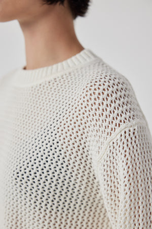 The back view of a woman wearing a KANAN SWEATER by Velvet by Jenny Graham, a lightweight cotton cashmere blend sweater.