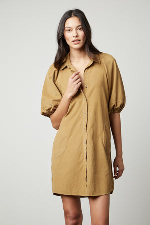 A model wearing the KADY CORDUROY BUTTON-UP DRESS by Velvet by Graham & Spencer.