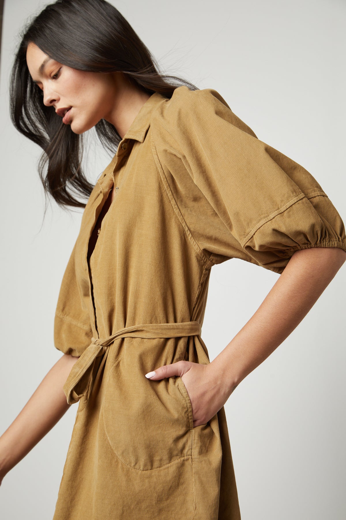 The model is wearing a Velvet by Graham & Spencer KADY CORDUROY BUTTON-UP DRESS.-26727742111937
