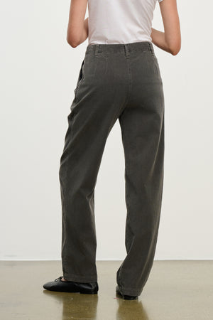 A person stands with their back to the camera on a polished floor, wearing a white t-shirt and Velvet by Graham & Spencer’s GAIL CORDUROY PANT— a relaxed, high-waisted, straight-leg cotton corduroy trouser.