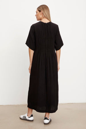 The back view of a woman wearing a Velvet by Graham & Spencer ASHLEIGH COTTON GAUZE MAXI DRESS.
