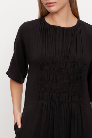 A woman wearing the ASHLEIGH COTTON GAUZE MAXI DRESS by Velvet by Graham & Spencer.
