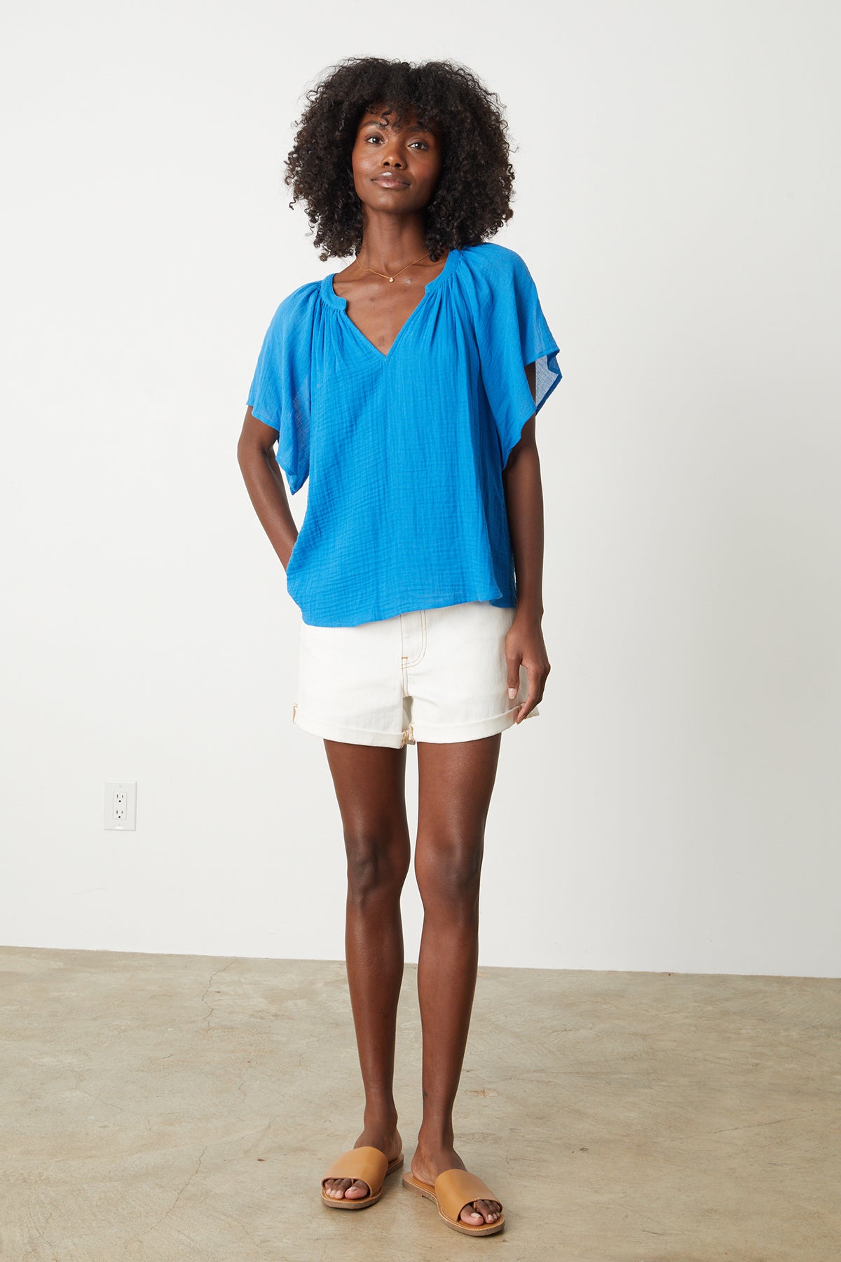 The model is wearing the BELLE COTTON GAUZE BLOUSE by Velvet by Graham & Spencer.-26342710804673