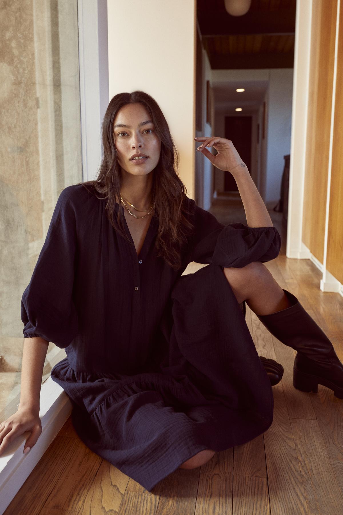 A woman is sitting on the floor in a Velvet by Graham & Spencer Dixon Cotton Gauze Tiered Dress.-26737005723841