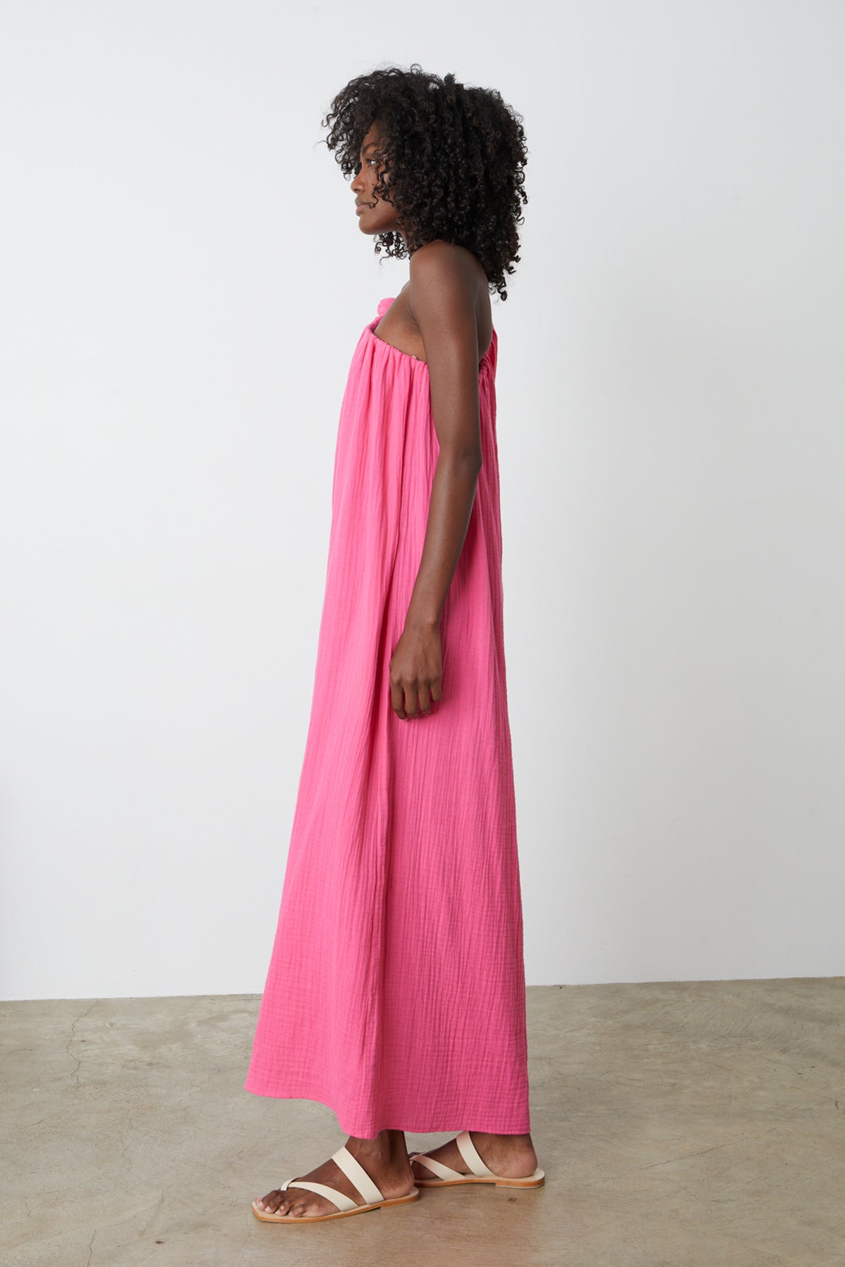 The back view of a woman wearing a Velvet by Graham & Spencer LAUREN COTTON GAUZE MAXI DRESS.-35205213585601