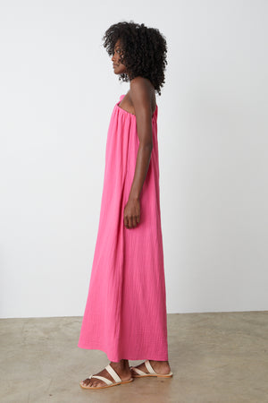 The back view of a woman wearing a Velvet by Graham & Spencer LAUREN COTTON GAUZE MAXI DRESS.