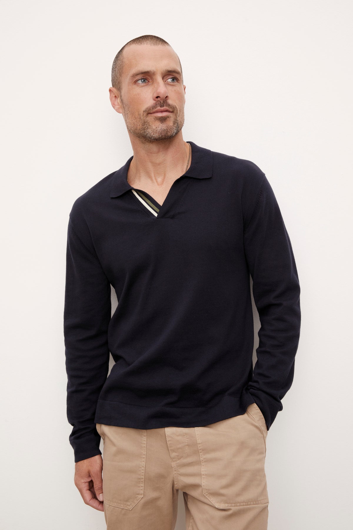 A man wearing a Velvet by Graham & Spencer RICO polo shirt and khaki pants.