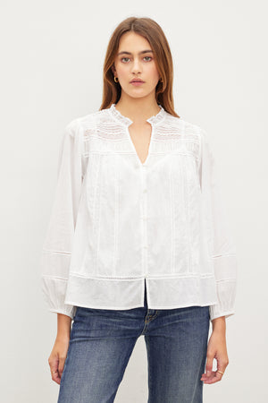 A woman in the LIAM COTTON LACE BUTTON FRONT TOP by Velvet by Graham & Spencer.