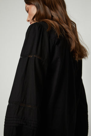 The back view of a woman wearing a Velvet by Graham & Spencer ROMY LACE BOHO TOP.