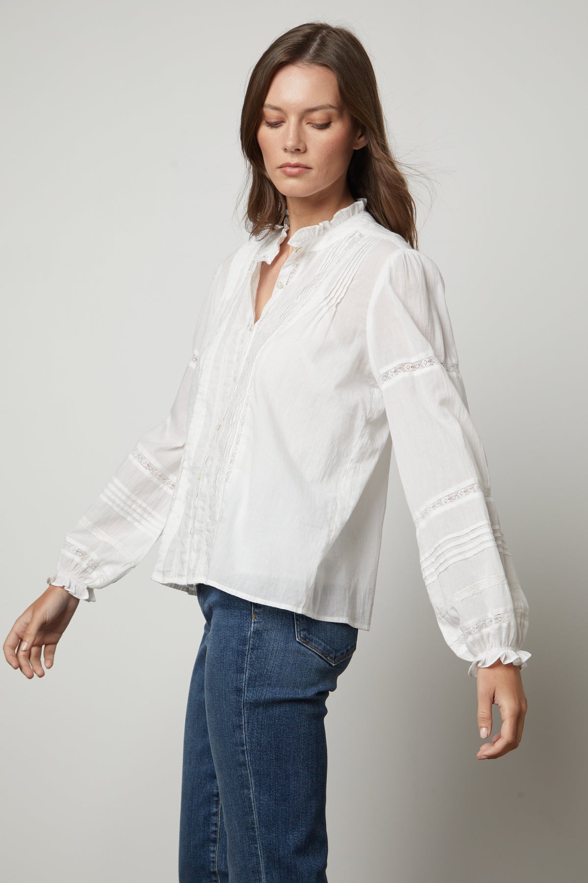 The model is wearing a ROMY LACE BOHO TOP by Velvet by Graham & Spencer.-26834995577025