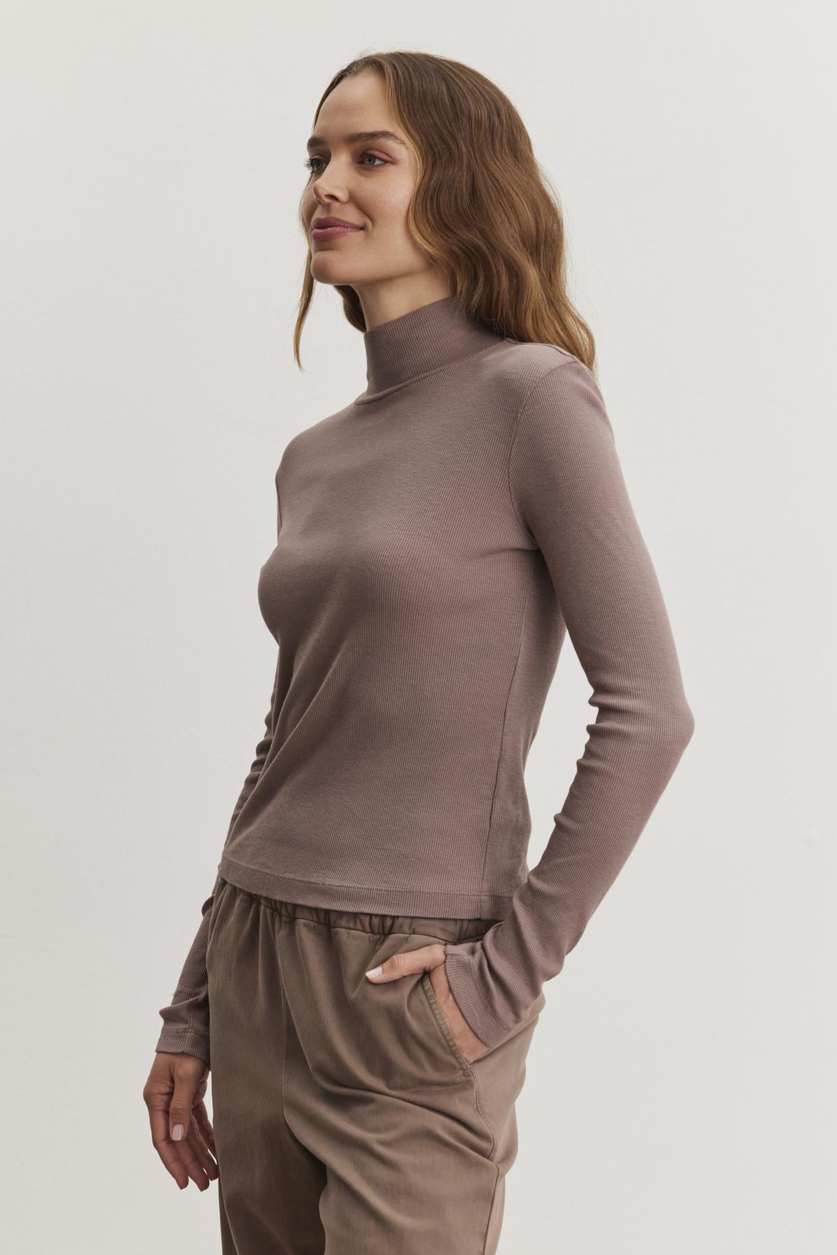 An individual dressed in the ADRIAN TEE by Velvet by Graham & Spencer and matching pants, standing against a plain background.-38483543785665