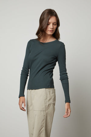 The model is wearing a Velvet by Graham & Spencer BAYLER RIBBED SCOOP NECK TEE and khaki pants.