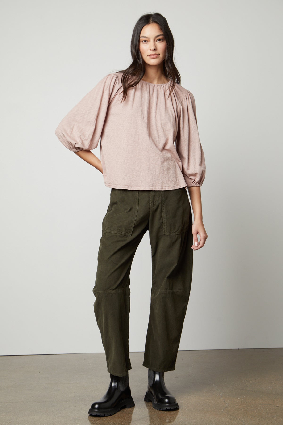 The model is wearing olive trousers and a Velvet by Graham & Spencer JULIE 3/4 SLEEVE TEE.